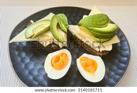 Sandwiches with cheese, avokado and eggs on black plate background. Healthy food. Diet concept. High quality photo Royalty-Free Stock Photo #2140185711
