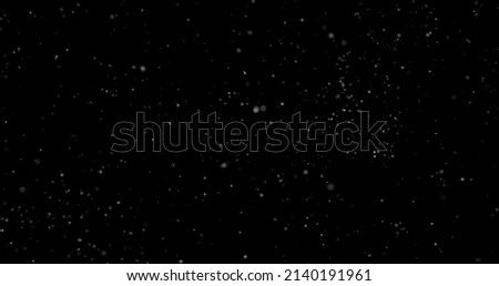 Flying dust particles on a black background Royalty-Free Stock Photo #2140191961