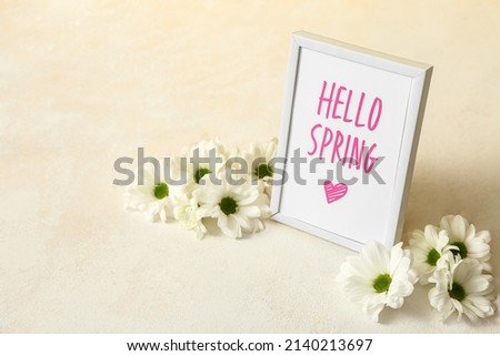 Picture frame with text HELLO SPRING and chrysanthemum flowers on light background
