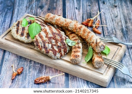 Home made Grilled sausages and Meatballs on wooden rustic background