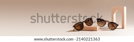 Trendy Sunglasses sale banner. Summer sale-out offer. Sunglasses in plastic frame on a beige background. Minimalism. Copy space for text. Eyewear banner, web line. Optic store discount.