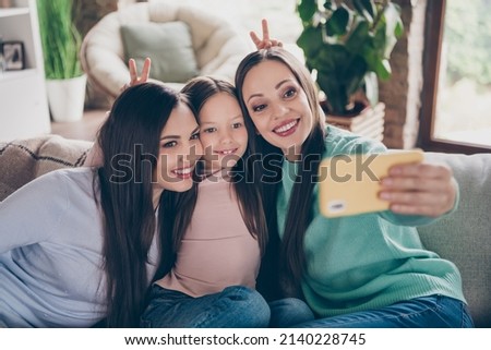 Photo of positive nice funky family sit couch phone selfie portrait make v-sign wear casual clothes home indoors