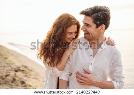 Happy fun young couple two friends family man woman in casual clothes hug girlfriend put head on boyfriend shoulder at sunrise over sea beach ocean outdoor exotic seaside in summer day sunset evening