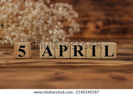 Calendar for April 5: cubes with the number 5, the name of the month of April in English. April holidays and significant dates. High quality photo