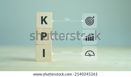 Banner KPI concept. Key Performance Indicator using business intelligence metrics to measure achievement versus planned target.  Wooden cubes with "KPI" abbreviation and symbols on smart background. Royalty-Free Stock Photo #2140245261