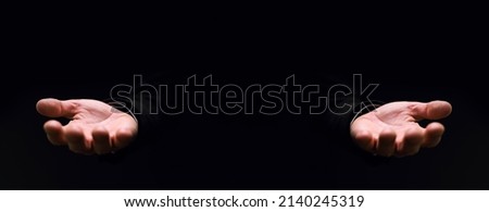 Businessman pleading hand reaching out from the dark, selective focus Royalty-Free Stock Photo #2140245319