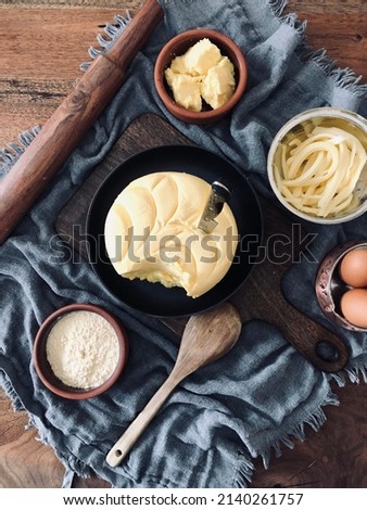 Close up Butter and knife on wooden table. Natural homemade cow butter and egg. Kitchen equipments and dairy products.