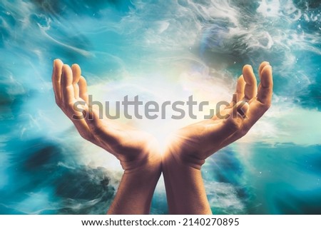 Close up of conceptual hand sending cosmic healing energy to universe.