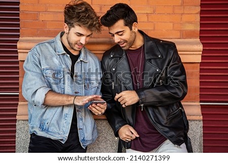 Two boys looking at phone.