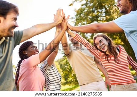 Group of young people giving high five for friendship and cooperation Royalty-Free Stock Photo #2140275585