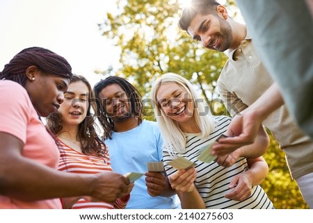 Young people work together to solve a task in an outdoor team building game Royalty-Free Stock Photo #2140275603