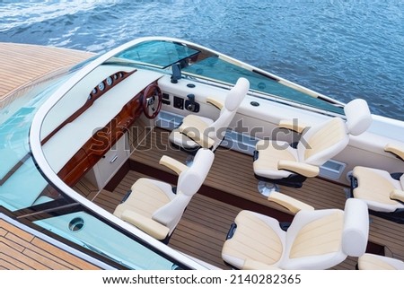 Speedy motor boat. Boat trips. An empty cabin of a motor boat. Leather seats and wooden trim of a luxury yacht. Sale of passenger ships. Recreation on the water. Royalty-Free Stock Photo #2140282365