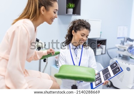 Treatment of cervical disease. Female gynecologist unrecognizable woman patient in gynecological chair during gynecological check up. Gynecologist examines a woman. Diagnostic, medical service.