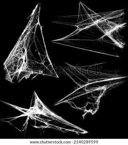 Overlay the cobweb effect. A collection of spider webs isolated on a black background. Spider web elements as decoration to the design. Halloween Props Royalty-Free Stock Photo #2140289599