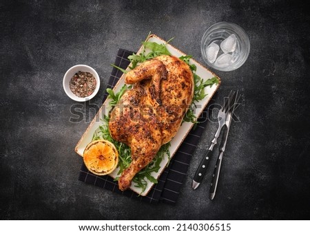 Grilled chicken. Half baked chicken with lemon and spices. Delicious juicy chicken. Grilled poultry. Royalty-Free Stock Photo #2140306515