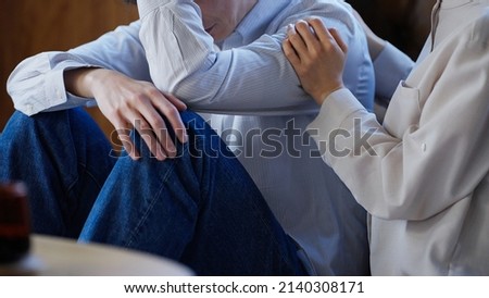Depressed Husband and Comforting Wife Royalty-Free Stock Photo #2140308171