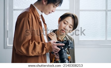 Male photographer and female model taking a picture