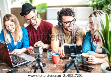 Young happy students sharing content on streaming platform with digital web cam - Modern life style concept with millenial guys and girls having fun vlogging live feeds on social media - Vivid filter