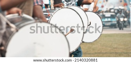 Musical background.Drum kit on stage lights performance.Live music.Concert and band on stage.Festival and show background.Blurry background of drummers, crowd with musical drums 