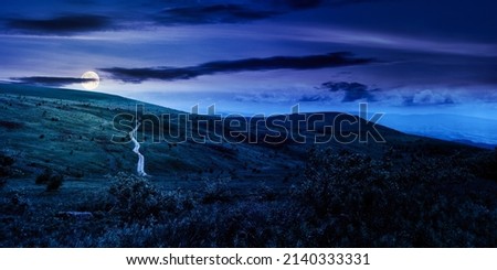 carpathian mountain landscape in summer at night. dirt road and hiking trail track. panoramic view of a hilly countryside in full moon light. fairy tale spooky looking abstract picture