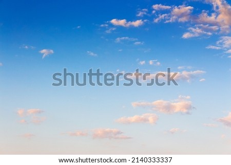 bright blue sky in the morning. clouds glowing in pink light. sunny atmosphere abstract background in summer. freedom concept