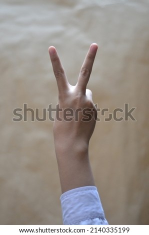 Woman's hand on a brown background