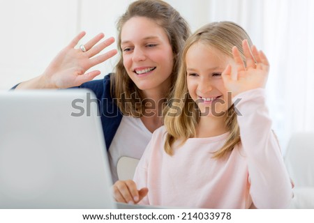 View of a Attractive woman and little sister videocalling Royalty-Free Stock Photo #214033978