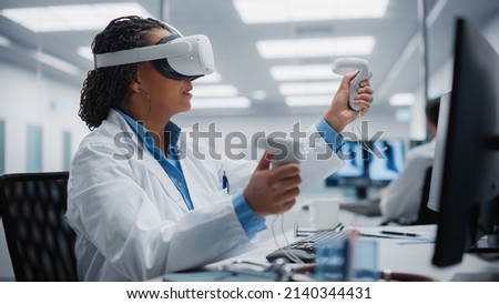 Futuristic Medical Hospital: Neurosurgeon Wearing Virtual Reality Headset Uses Controllers to Remotely Operate Patient with Medical Robot. Modern High-Tech Advance in Breakthrough Medical Treatment Royalty-Free Stock Photo #2140344431