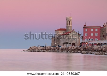 Piran, Slovenia. Cityscape image of Piran, Slovenia with historical church and lighthouse at sunrise. Royalty-Free Stock Photo #2140350367