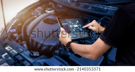Smart Car Service  Diagnostics Software concept.Mechanic using digital tablet Inspecting the Vehicle Royalty-Free Stock Photo #2140353371