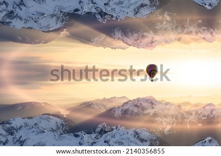 Magical Fantasy Aerial Landscape with a mirrored Mountain World. Hot Air Balloon Flying. Adventure Composite. Nature Background Image from British Columbia, Canada. Sunset Sky