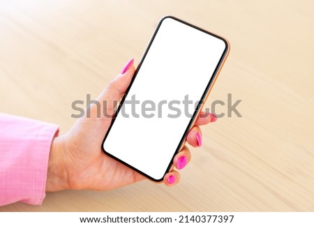 Close-up photo of cell phone in woman's hand, empty white screen mockup