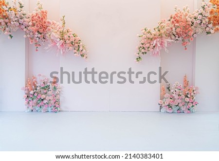 Beautiful wedding pink plastic flower and decoration backdrop pastel style for taking pictures.