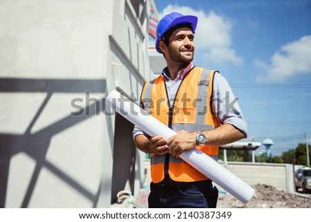 Handsome engineer man and architect working at construction site with calculate spending report inside house. Real Estate Project with Civil Engineer Royalty-Free Stock Photo #2140387349