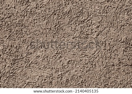 Painted wall with rough texture closeup. Brown plaster with brushed texture, house wall, copy space