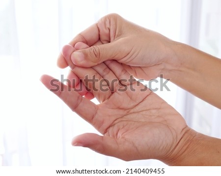 Close-up of body people with hand pain, sore finger and numbness in fingertips, Rheumatoid arthritis.