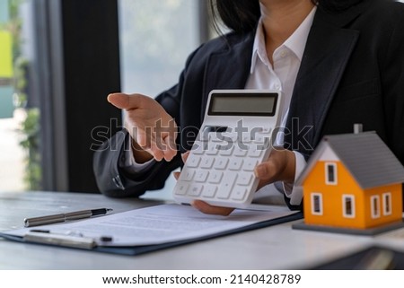 Business Signing and analyzing a contract buy - sell house, insurance agent analyzing cost about home investment loan Real Estate