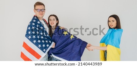 Friends holding American, Ukraine and EU flag. Stop war in Ukraine