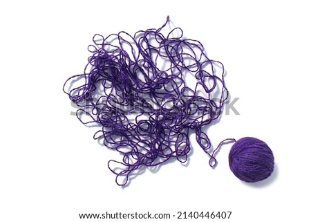 Tangled threads with a ball lie on a white background. Royalty-Free Stock Photo #2140446407