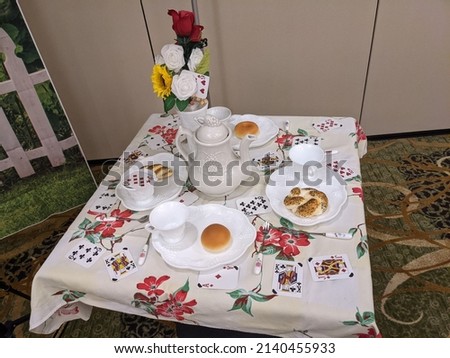 Alice in Wonderland tea party set with playing cards and food