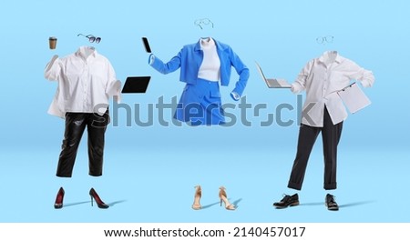 Female team. Creative artwork. Invisible women wearing modern business style outfit and eyeglasses standing against blue background. Concept of fashion, creativity, art and ad. Royalty-Free Stock Photo #2140457017