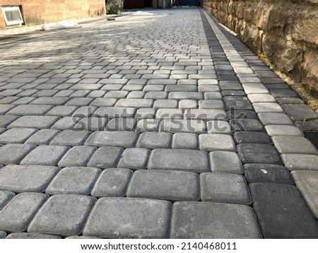 Nested pavers of various colors, around the grass is green, chic garden Royalty-Free Stock Photo #2140468011