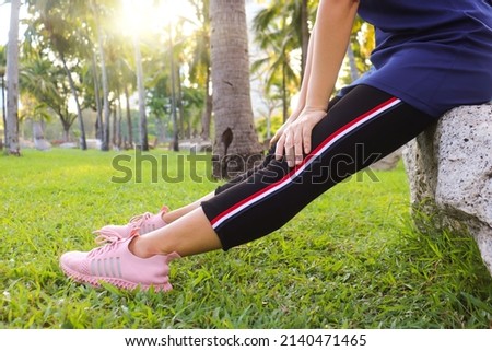 The concept of relieving back and muscle pain massaged bya woman exercising in the park