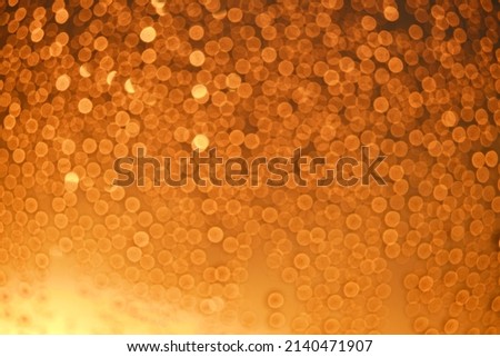 Blurred background window with drops water and bokeh red sun at sunset