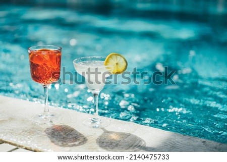 Refreshing cocktail near swimming pool, close up