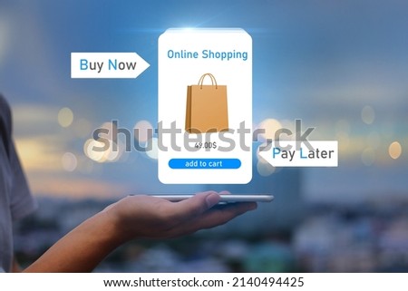 BNPL Buy now pay later online shopping concept.Hands holding mobile phone on blurred city as background Royalty-Free Stock Photo #2140494425