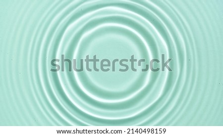 Top view of water circles on light green background | Beauty products background