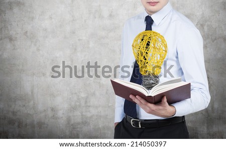 Businessman reading the book and has an idea