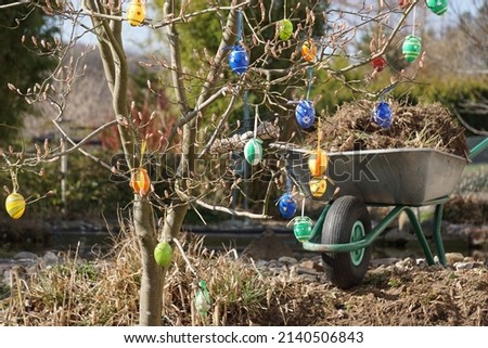 Traditional Festive Decorative Easter Eggs On The Tree In The Garden. Nature And Gardening Equipment. Spring Working In The Garden. Royalty-Free Stock Photo #2140506843