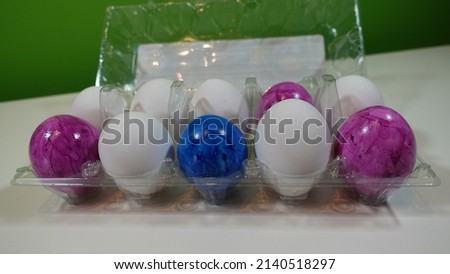 
a pack of eggs with a bunch of colored easter eggs